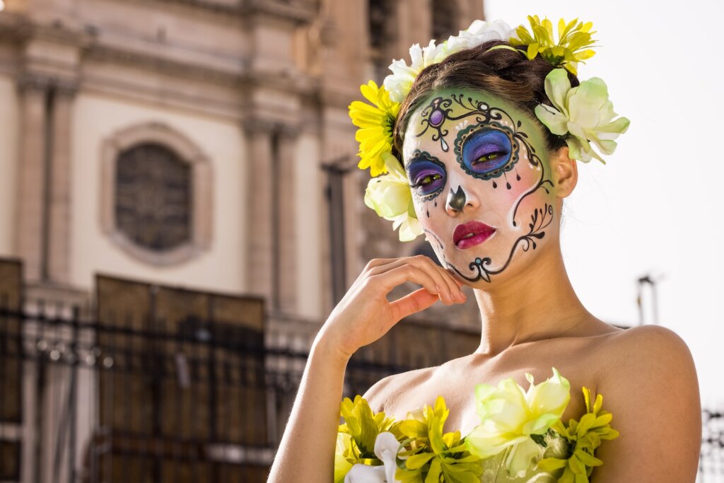 woman in yellow floral dress holding white flower bouquet